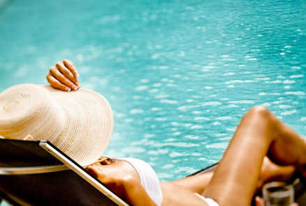 This is a picture of a guest relaxing by the pool at Beaver Creek Resort in Gaylord, MI