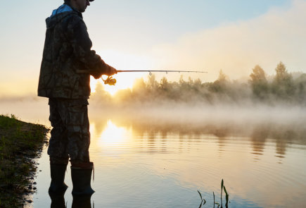 This is a picture of a guest fishing at the trout lake at Beaver Creek Resort in Gaylord, MI